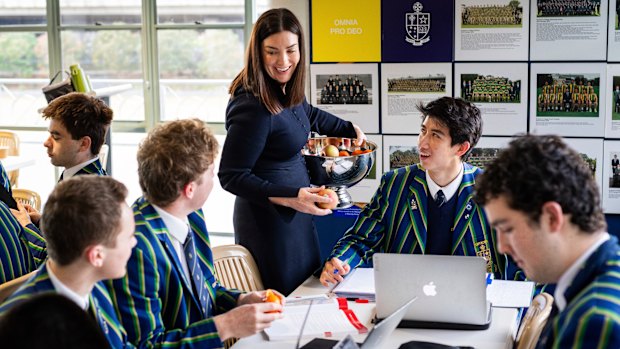 Director of teaching and learning Hannah Kollmorgen with St Kevins College year 12 students (from left) William Park, Austin Bylsma, Daniel and Angus Macmillan at the morning Cafe Academus program in the school’s pavilion.