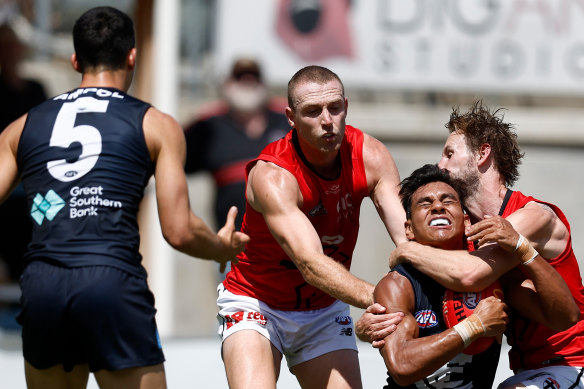 Blue Jesse Motlop (right) is taken high in a tackle.