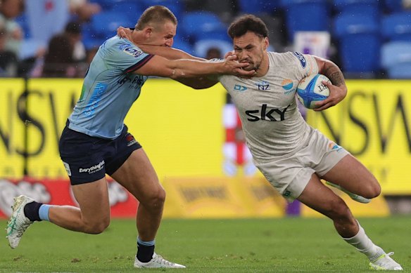 Moana Pasifika’s William Havili is tackled by Waratah Max Jorgensen on Friday night.
