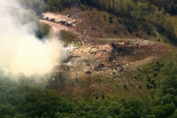 Smoke fills the air as debris covers the ground and vehicles after a powerful blast ripped through a military explosives manufacturing plant in Hickman County, Tennessee.