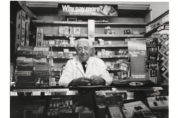 Mr Lindsay Williams at his barber and tobacconist shop, Errol Street, North Melbourne.