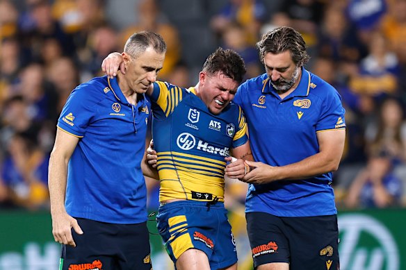 Eels hooker Ryley Smith is helped off with a sternum injury during Saturday’s defeat to the Warriors.