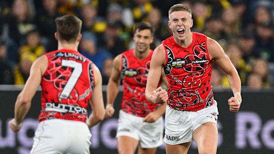 Nate Caddy of the Bombers celebrates kicking a goal.