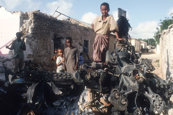 Children stand on the wreckage of a US helicopter shot down during a raid over the Somali capital Mogadishu in 1993.
