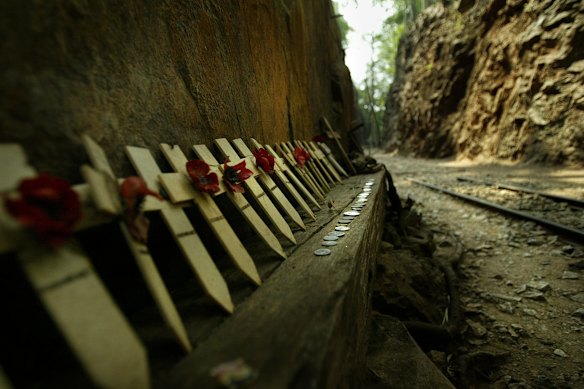 Remembrance crosses bearing poppies at Hellfire Pass in Thailand.