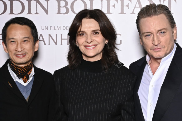 Tran Anh Hung, Juliette Binoche and Benoit Magimel astatine  the Paris premiere of The Taste of Things.