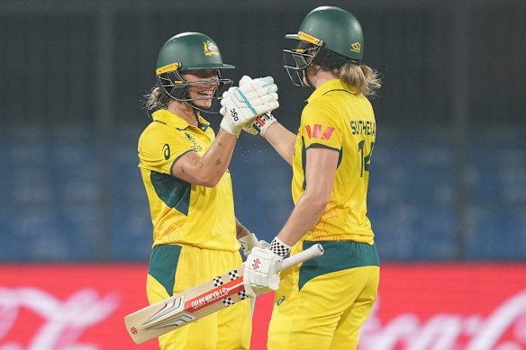 Australia’s Ashleigh Gardner, left, celebrates her century with Annabel Sutherland.