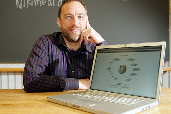 Jimmy Wales in 2006 with an early iteration of Wikipedia.