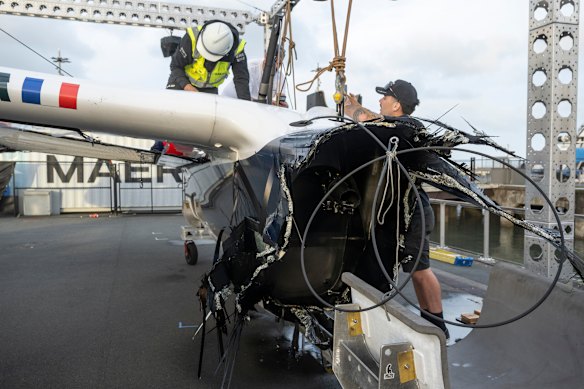 The damaged hull on Team France in Auckland.