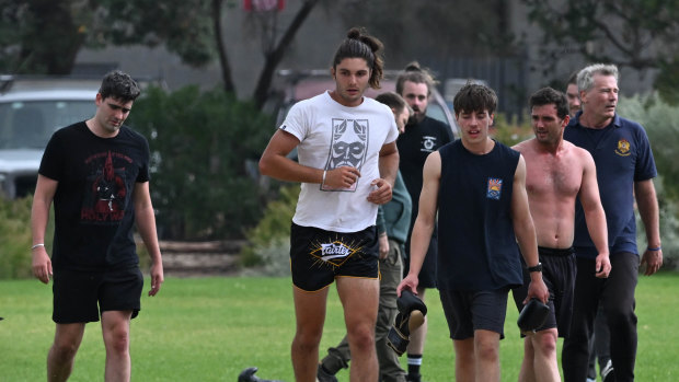 Jacob Hersant, in black and red T-shirt, and others conduct fitness drills in Elwood.
