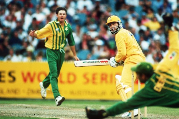 Greg Blewett bowling for Australia A against Mark Taylor and Australia in 1995.
