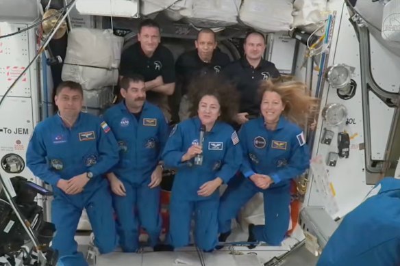 Foreground from left, Russian Andrey Fedyaev, Americans Jack Hathaway and Jessica Meir and France’s Sophie Adenot, gather with, background from left, Russian Sergey Kud-Sverchkov, American Christopher Williams and Russian Sergei Mikayev, after a new crew entered the ISS in February.