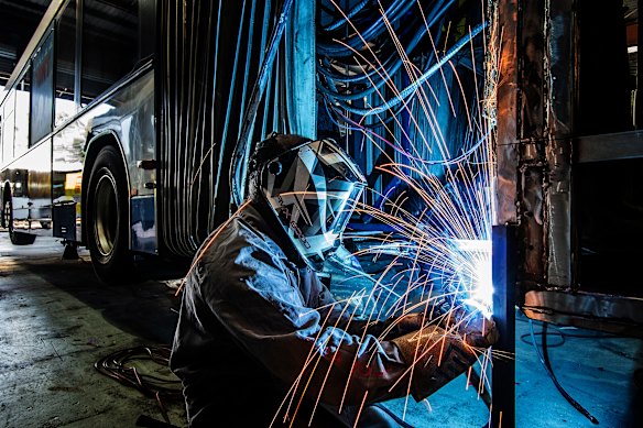 Worker Isra Nand carries out repairs to a bendy bus at a maintenance facility at Smithfield in Sydney’s west.