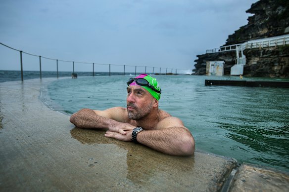 A local braves the rain to get laps in at Bronte’s ocean pool on Wednesday morning.