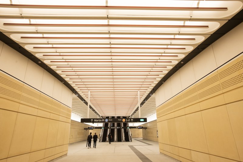 Red detailing in the ceiling at Martin Place Metro Station guides commuters towards the city centre.