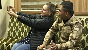 Selfie time: Photographer Kate Geraghty with a Kurdish border patrolman on the Iraq-Syria border in October, 2018.