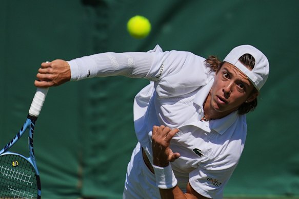 Arthur Cazaux serves the ball to Alex de Minaur.