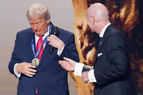 US President Donald Trump receives the FIFA Peace Price from Gianni Infantino in December, 2025.
