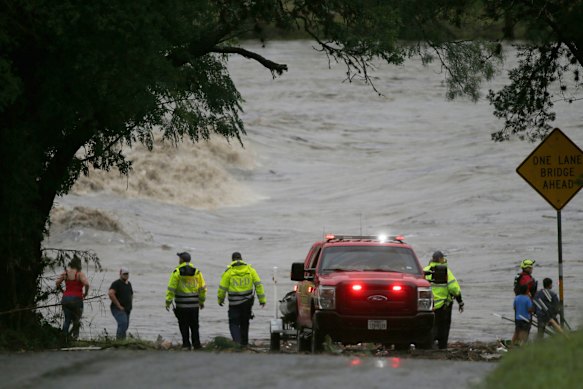First responders scan the banks of the Guadalupe River for individuals swept away by flooding in Ingram, Texas.