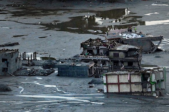 Body bags lay on the roof of a destroyed building in Betrawoti.