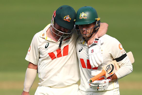 Best mates Head and Alex Carey leave the Adelaide Oval turf on day three, arm in arm.