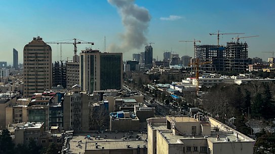 A plume of smoke rises following a reported explosion in Tehran.