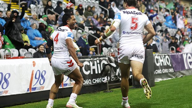 Matthew Feagai celebrates a try for the Dragons.