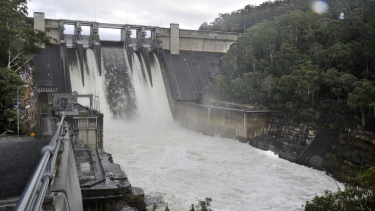 Water flows over the wall at Warragamba Dam.