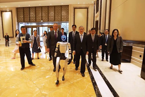 WA Premier Roger Cook being led by a robot into the 10th Biennial Western Australia-Zhejiang Exchange Committee meeting in China.  