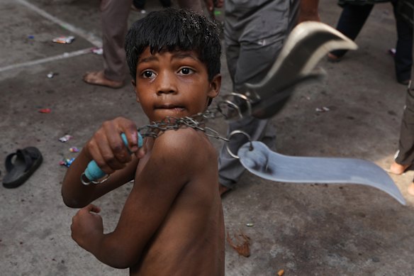 A Shiite Muslim child flagellates himself during a Muharram procession in Ahmedabad, India.