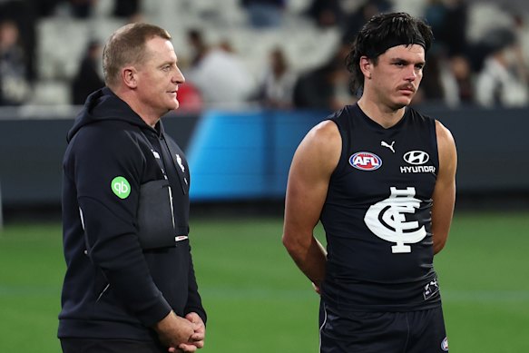 Elijah Hollands (right) with Blues coach Michael Voss after the loss to Collingwood.