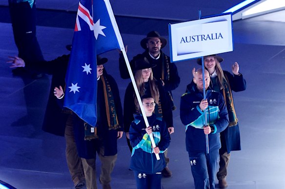Ethan Jackson, Georgia Gunew and Liana France represent team Australia at the Milano Cortina Paralympic Games opening ceremony.