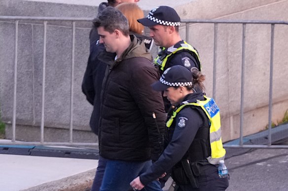 Police lead away white supremacist Jacob Hersant, who heckled the Welcome to Country at the dawn service at Melbourne’s Shrine of Rememberance.