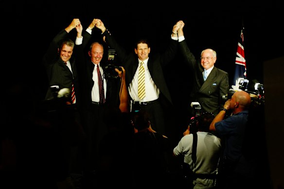 Deputy Prime Minister John Anderson, State Deputy Opposition leader Bob Quinn, state National Party leader Lawrence Springborg and Prime Minister John Howard saluting the party faithful at the 2004 campaign launch.