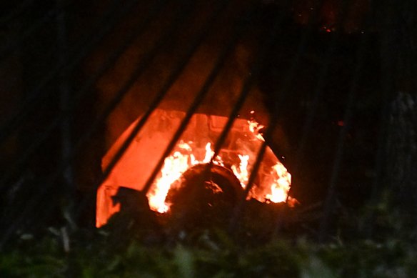 A vehicle burns at La Carlota air base in Caracas after a series of explosions.