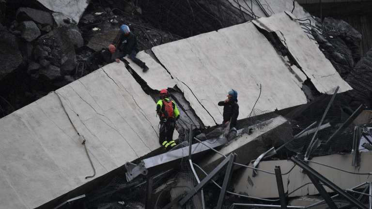 Rescue workers among the debris of the collapsed bridge.