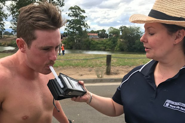 Amy Peden breath-testing a volunteer as part of her research.