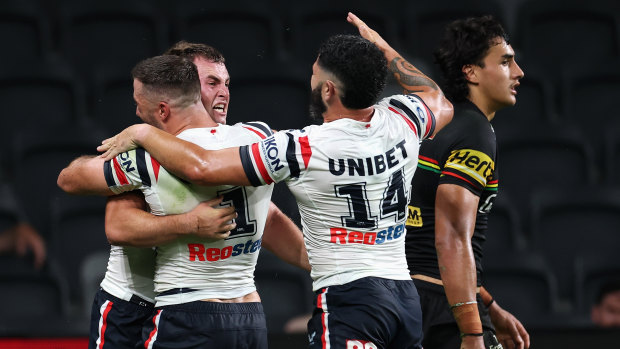 The Roosters celebrate Sandon Smith’s try.