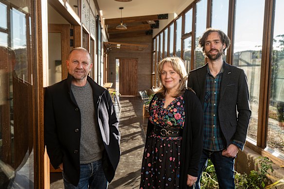 Grand Designs Australia host Anthony Burke (left) with Kate and Matt inside their earthship house. 