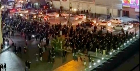 A screen grab showing people blocking an intersection during a protest in Tehran on Friday (AEDT).