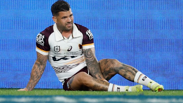 Adam Reynolds lies injured on the ground.