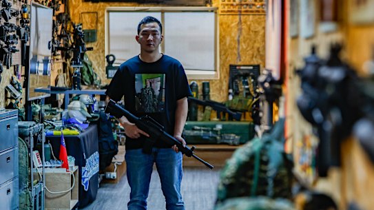 Tony Lu, 35, gives talks to school students at Taiwan Airsoft and Airgun Association about his experience fighting in Ukraine in 2022. He is wearing a T-shirt with the portrait of his friend, Australian Trevor Kjeldal, who died in battle in Ukraine.