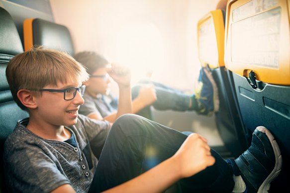 A polite “Excuse me, I think your child’s feet are pushing against my seat. Could you help with that?” will usually suffice.
