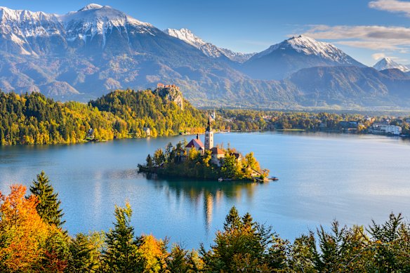The Julian Alps rise up behind Bled Island in Slovenia.