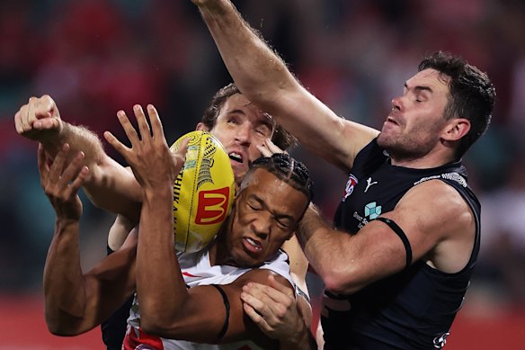 Joel Amartey of the Swans leaps for a mark against Carlton.