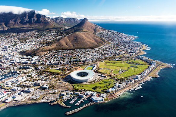 An aerial view of Cape Town with a view of Table Mountain and the city’s stadium. 