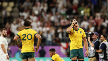 Burden of defeat: The Wallabies reel after their heavy quarter-final loss to England.