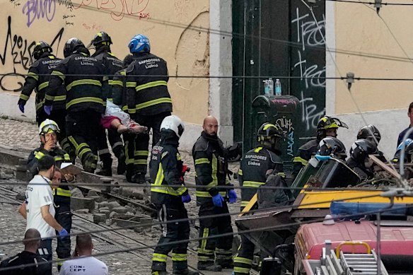 Firefighters carrying a person on a stretcher after the crash.