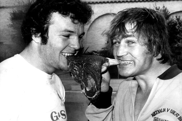 Les Boyd and Tommy Raudonikis rip into a raw steak.
