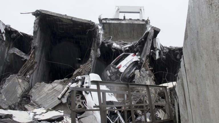 Cars are seen among the rubble of the collapsed bridge.